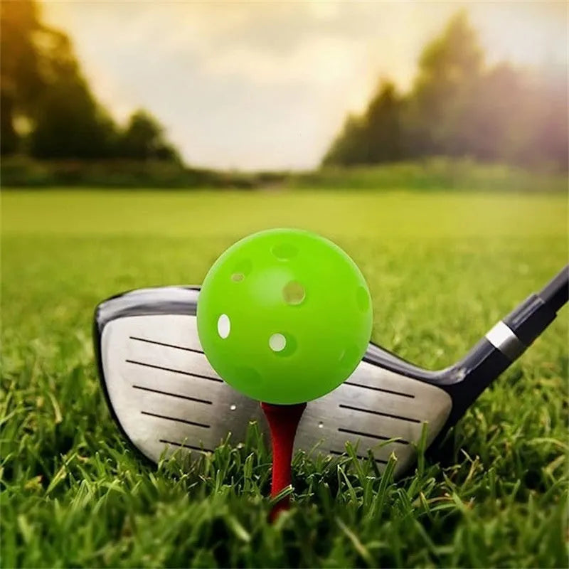 Multi-colour golf practice balls showing red, orange, blue, green, white and yellow variants with 26-hole design
