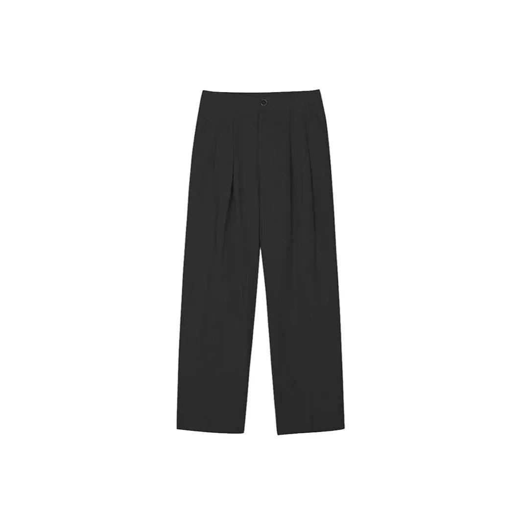 Man wearing apricot wide-leg cotton linen trousers with a mid waist and zip fly.