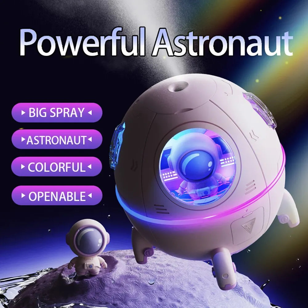 Purple astronaut-shaped USB desktop humidifier with colourful LED light on wooden desk
