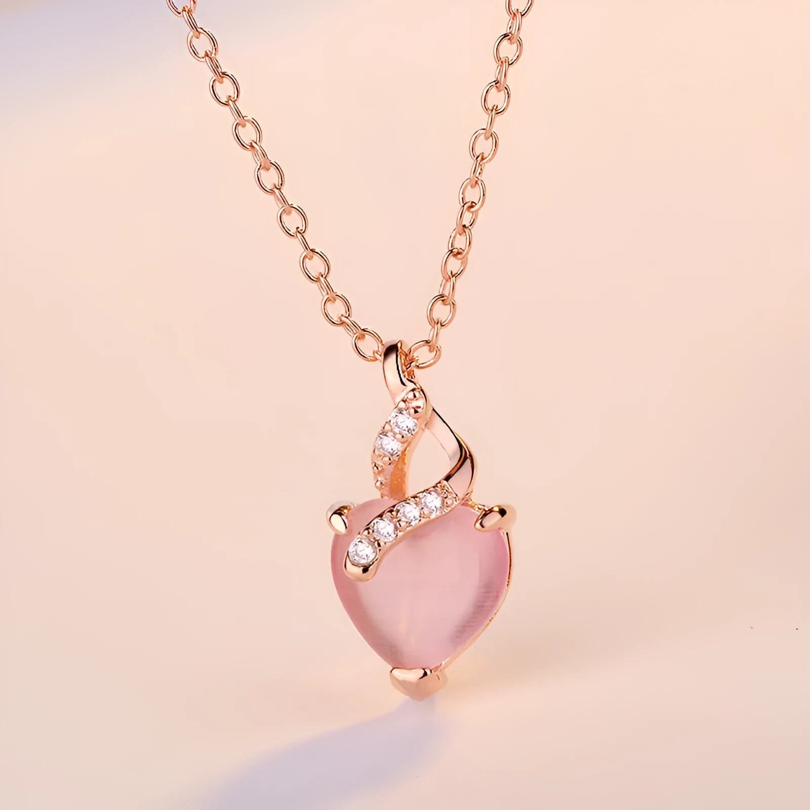 Women's heart-shaped pink synthetic crystal pendant necklace on rose gold cross chain