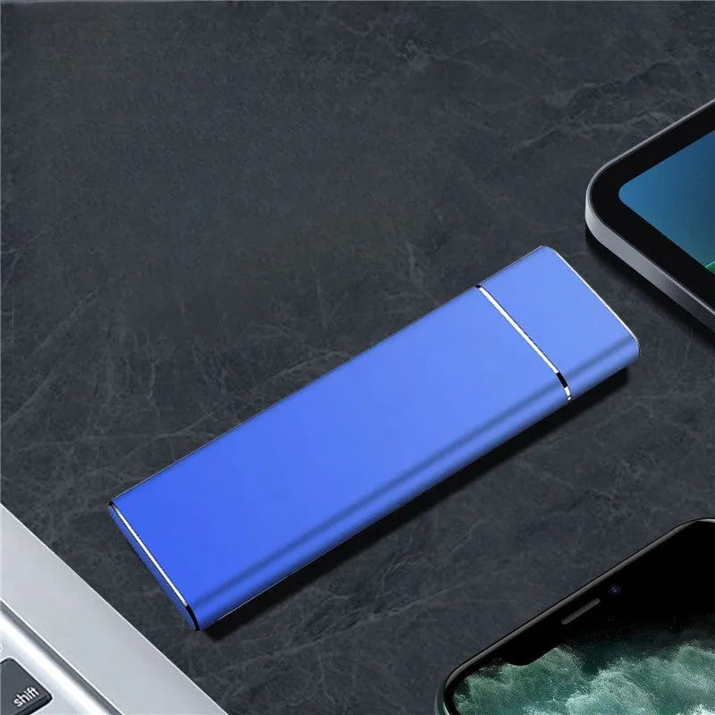 Sapphire blue metal external hard drive with USB cable on a white surface.