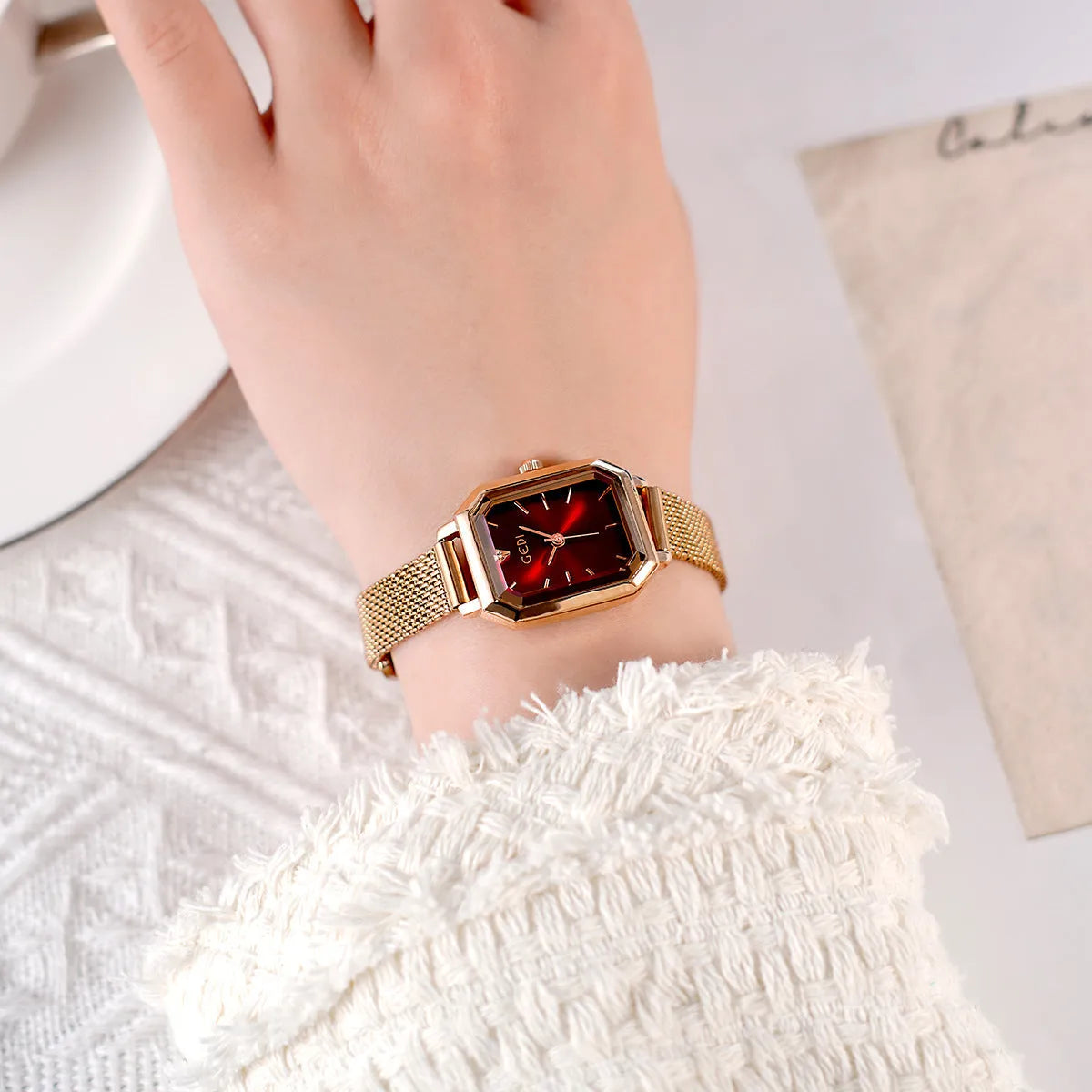 Square rose gold casual watch with black dial and black leather strap showing 8mm thickness