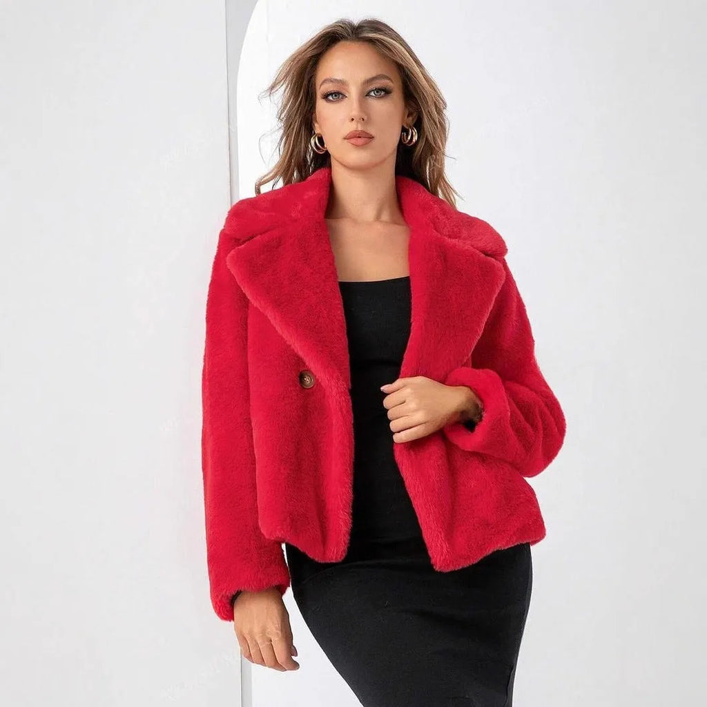 Women's loose-fitting short faux fur coat in rose red colour on a hanger.